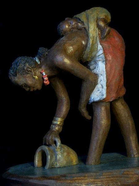 African Woman dipping water with baby